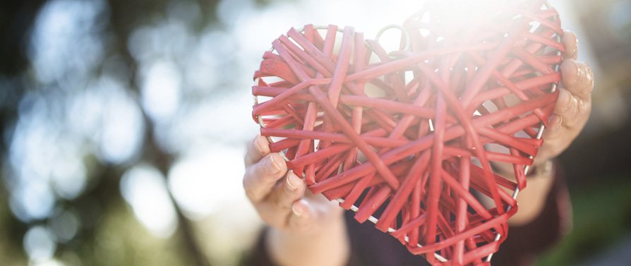 Illustration: a heart held aloft